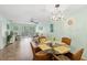 Inviting dining room featuring a glass table, wicker chairs, and a stylish light fixture at 2639 Woodgate Ln # H8, Sarasota, FL 34231