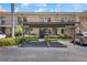 Charming condo building featuring assigned covered parking and well-maintained landscaping at 2639 Woodgate Ln # H8, Sarasota, FL 34231