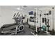 Gym featuring an elliptical, treadmill, weight rack and television at 2639 Woodgate Ln # H8, Sarasota, FL 34231