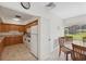 Galley kitchen with white appliances, wood cabinets, and a breakfast nook at 2639 Woodgate Ln # H8, Sarasota, FL 34231