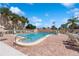 Large community pool surrounded by brick pavers, lounge chairs, and palm trees at 2639 Woodgate Ln # H8, Sarasota, FL 34231