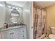Hall bath features granite counters, white vanity, tub-shower combination and updated lighting at 2763 Woodgate Ln # 211, Sarasota, FL 34231