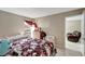 Cozy bedroom with a window, dresser, and a recliner through the door at 2763 Woodgate Ln # 211, Sarasota, FL 34231