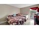 Bright bedroom with two twin beds, light wood floors, and a window at 2763 Woodgate Ln # 211, Sarasota, FL 34231