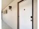 Condo front door featuring an exterior sconce light, windows, and the unit number displayed on the wall at 2763 Woodgate Ln # 211, Sarasota, FL 34231