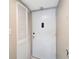 Interior view of the front door with white door and closet, neutral paint, and white trim at 2763 Woodgate Ln # 211, Sarasota, FL 34231