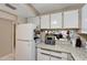 Functional kitchen features white cabinets, granite countertops, and stainless steel appliances at 2763 Woodgate Ln # 211, Sarasota, FL 34231