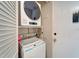 Convenient laundry area with stacked washer and dryer and door to the outside at 2763 Woodgate Ln # 211, Sarasota, FL 34231