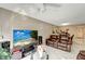 Spacious living room with tile flooring, a ceiling fan, and large windows for natural light at 2763 Woodgate Ln # 211, Sarasota, FL 34231