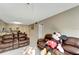 View of living room with tile floors, a ceiling fan, and comfortable seating arrangements at 2763 Woodgate Ln # 211, Sarasota, FL 34231