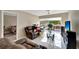 Living room showcasing tile flooring, large windows, a ceiling fan, and comfortable furniture at 2763 Woodgate Ln # 211, Sarasota, FL 34231