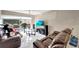 Living room featuring tile floors, large windows, a ceiling fan, and comfortable leather furniture at 2763 Woodgate Ln # 211, Sarasota, FL 34231