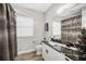 Elegant bathroom featuring a marble countertop vanity, modern fixtures, and stylish mirror at 2912 51St E St, Bradenton, FL 34208