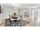 Dining room showcasing seating for eight, modern chandelier, zebra rug, and decor at 2912 51St E St, Bradenton, FL 34208