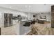 Contemporary kitchen with stainless steel appliances, white cabinetry, and an island with bar seating and stone counter tops at 2912 51St E St, Bradenton, FL 34208