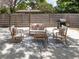 Backyard patio area featuring patio furniture, grill, and privacy fence at 2933 Michigan St, Sarasota, FL 34237