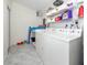 Bright laundry room features a modern washer and dryer and ample storage at 2933 Michigan St, Sarasota, FL 34237