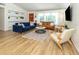 Well-lit living room with modern furniture, open shelving, and hardwood floors at 2933 Michigan St, Sarasota, FL 34237