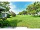 Expansive, well-maintained backyard featuring lush greenery and mature trees offering shade and privacy at 3276 Westford Ln, #117,, Sarasota, FL 34231