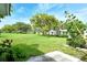 Expansive backyard featuring lush greenery, mature trees, and a peaceful residential setting at 3276 Westford Ln, #117,, Sarasota, FL 34231