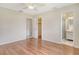 Spacious bedroom with hardwood floors featuring access to ensuite bathroom and closet at 3276 Westford Ln, #117,, Sarasota, FL 34231