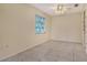 Neutral bedroom features tile flooring, a window overlooking the yard, and modern ceiling fan at 3276 Westford Ln, #117,, Sarasota, FL 34231