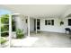 Spacious carport featuring white support beams and room for outdoor seating at 3276 Westford Ln, #117,, Sarasota, FL 34231