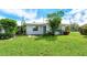 Cozy home exterior featuring well-manicured lawn, mature trees, and neutral paint scheme at 3276 Westford Ln, #117,, Sarasota, FL 34231
