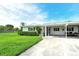 Inviting single-story home with lush green lawn and convenient covered parking at 3276 Westford Ln, #117,, Sarasota, FL 34231
