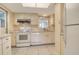 Well-maintained kitchen features white appliances, ample cabinet space, and neutral countertops at 3276 Westford Ln, #117,, Sarasota, FL 34231