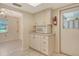 Functional kitchen area with white cabinetry, microwave, and convenient access to the adjacent dining area at 3276 Westford Ln, #117,, Sarasota, FL 34231