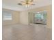 Spacious living room with tile flooring, ceiling fan, and slider door access at 3276 Westford Ln, #117,, Sarasota, FL 34231