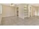 Open living space features tile flooring, built in shelves, and easy access to kitchen and bedrooms at 3276 Westford Ln, #117,, Sarasota, FL 34231
