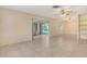 Expansive living room with tile floors and sliding glass doors that lead to a patio at 3276 Westford Ln, #117,, Sarasota, FL 34231