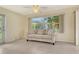 Bright living room featuring a comfortable couch, tile flooring, and large window with natural light at 3276 Westford Ln, #117,, Sarasota, FL 34231