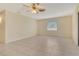 Bright and open living room with ceiling fan and view to the backyard at 3276 Westford Ln, #117,, Sarasota, FL 34231