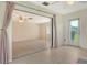Spacious room features tile flooring, glass doors to outdoor space, and modern ceiling fan at 3276 Westford Ln, #117,, Sarasota, FL 34231