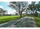 Enjoy a game of shuffleboard in this community setting, surrounded by mature trees at 3276 Westford Ln, #117,, Sarasota, FL 34231