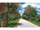 Beautiful walking path lined with lush green trees, creating a peaceful atmosphere at 3276 Westford Ln, #117,, Sarasota, FL 34231