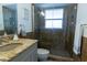 Bathroom with tiled shower, granite vanity and neutral fixtures at 3338 Roslyn Rd, Venice, FL 34293