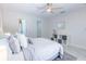 Bright bedroom with ceiling fan, recessed lights, and a view to the walk-in closet featuring neutral décor at 3338 Roslyn Rd, Venice, FL 34293