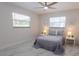 Bright and serene bedroom with a ceiling fan and two windows provides plenty of natural light at 3338 Roslyn Rd, Venice, FL 34293