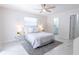 This cozy bedroom features a ceiling fan, neutral decor and an ensuite bathroom creating a relaxing retreat at 3338 Roslyn Rd, Venice, FL 34293
