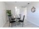 Cozy dining area featuring a glass-top table, elegant decor, and marble flooring for a refined atmosphere at 3338 Roslyn Rd, Venice, FL 34293