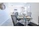 Open-concept dining area with a view into the living room, featuring modern furniture and decor at 3338 Roslyn Rd, Venice, FL 34293