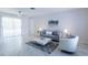 Bright, minimalist living room with stylish marble flooring and a comfortable seating arrangement at 3338 Roslyn Rd, Venice, FL 34293