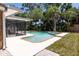 Backyard swimming pool and patio area surrounded by mature trees at 3338 Roslyn Rd, Venice, FL 34293