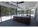Covered and screened lanai with ceiling fans and wicker furniture at 3338 Roslyn Rd, Venice, FL 34293