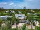 Aerial view of home with white exterior, lush landscaping, and modern roof at 3737 Bayou Louise Ln, Sarasota, FL 34242