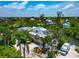 Aerial view of home with lush landscaping, modern roof, and boat dock at 3737 Bayou Louise Ln, Sarasota, FL 34242